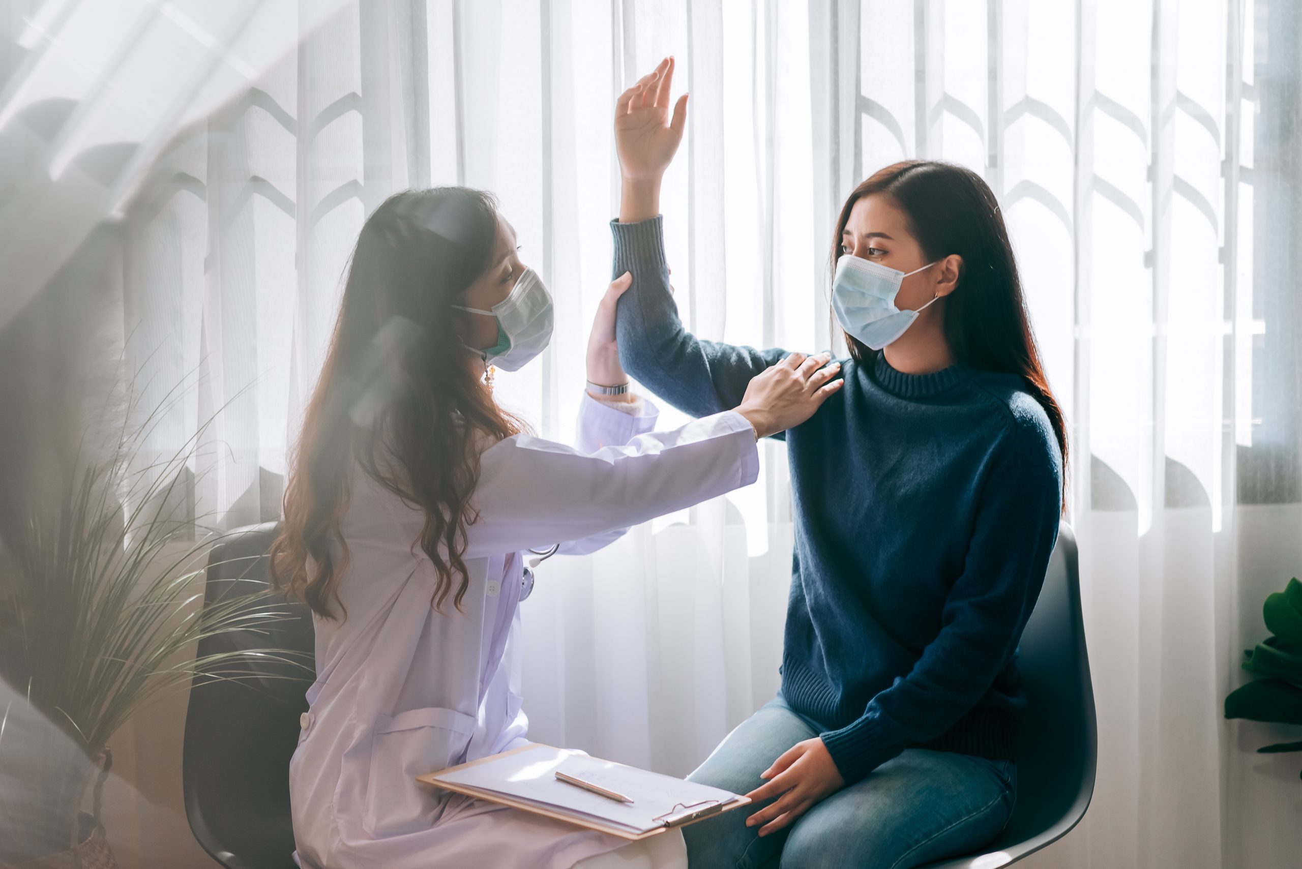 asian-doctor-visit-examines-young-adult-woman-hospital-with-office-syndrome-symptomthe-doctor-checking-up-consulting-health-care-wearing-mask-protect-covid19-pandemic